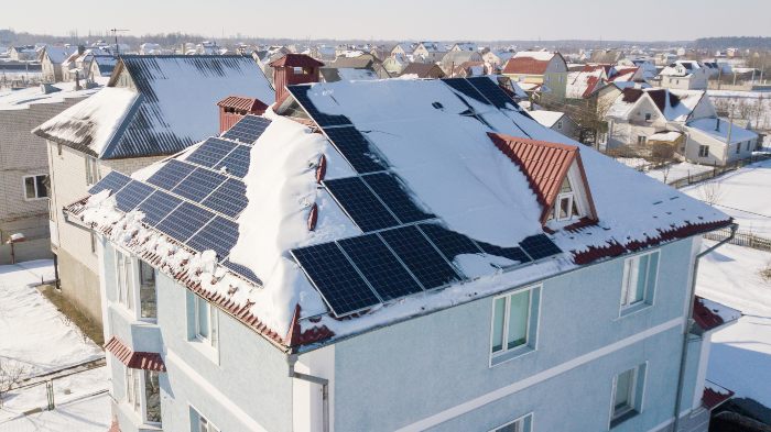 Solar system on the roof with snow in winter. Remove snow from